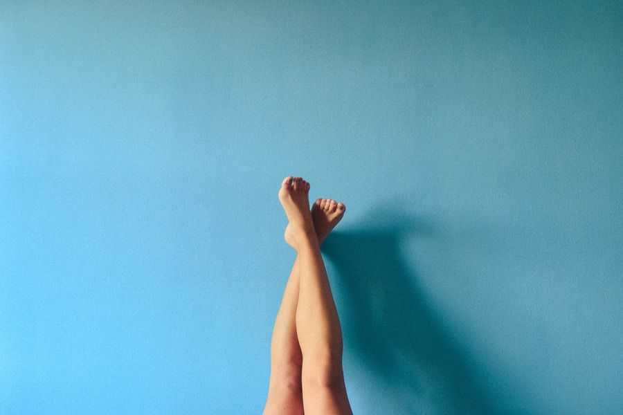 legs on blue wall